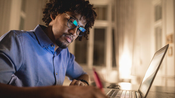 student studying at night on laptop