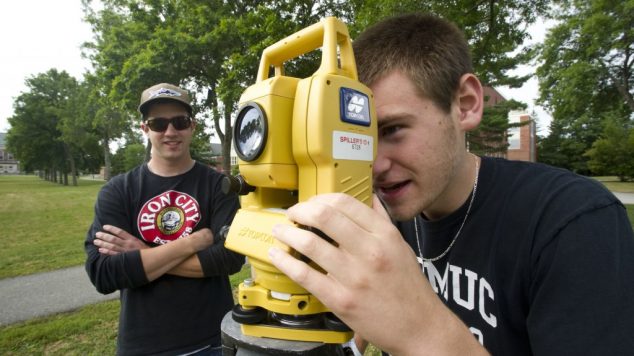 student looking through surveying equipment