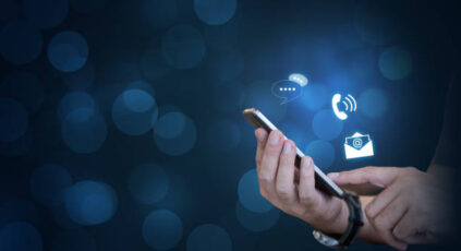 hands holding a cellphone with iicons for email, phone and chat