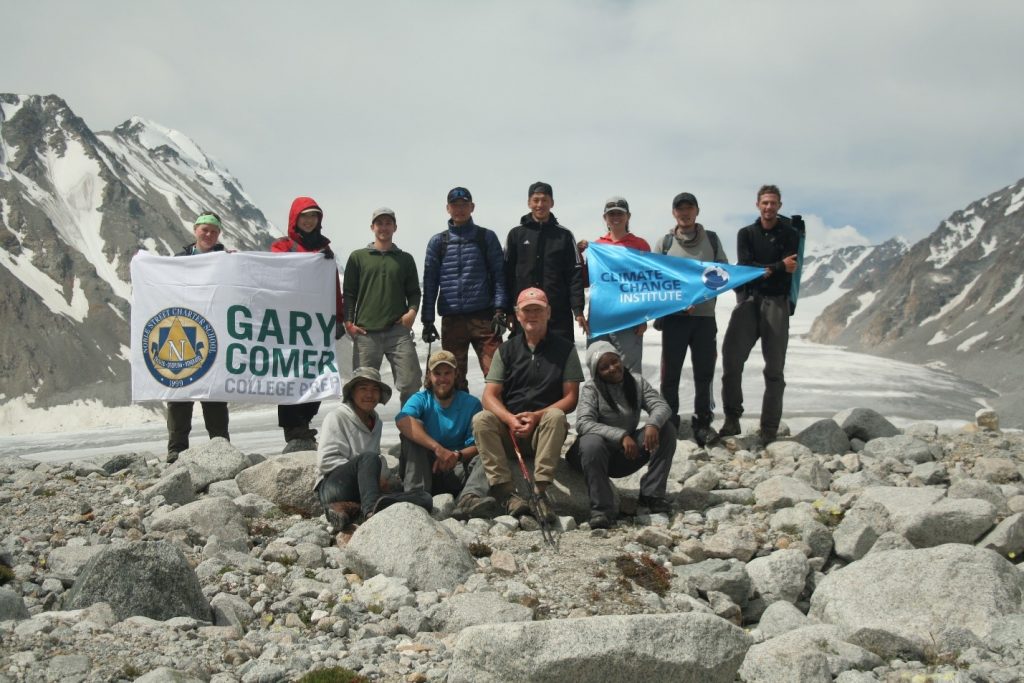 Field team members in front of a glacier. Photo credit: Kevin Stark