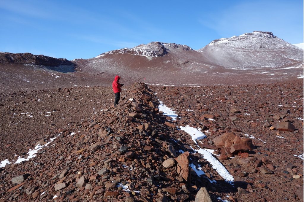 A moraine ridge, a mound of debris deposited by the glacier, extends down the center of the photograph.