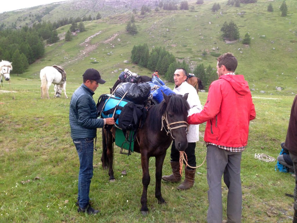 Mongolian herders help Aaron Putnam pack horses