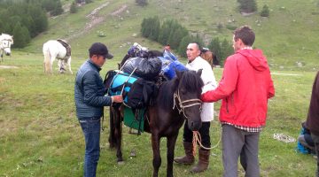 Mongolian herders help Aaron Putnam pack horses