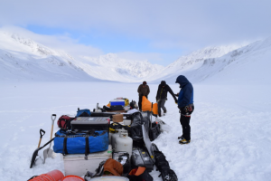 team with their gear on the glacier