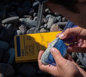 Student measuring cobble diameter