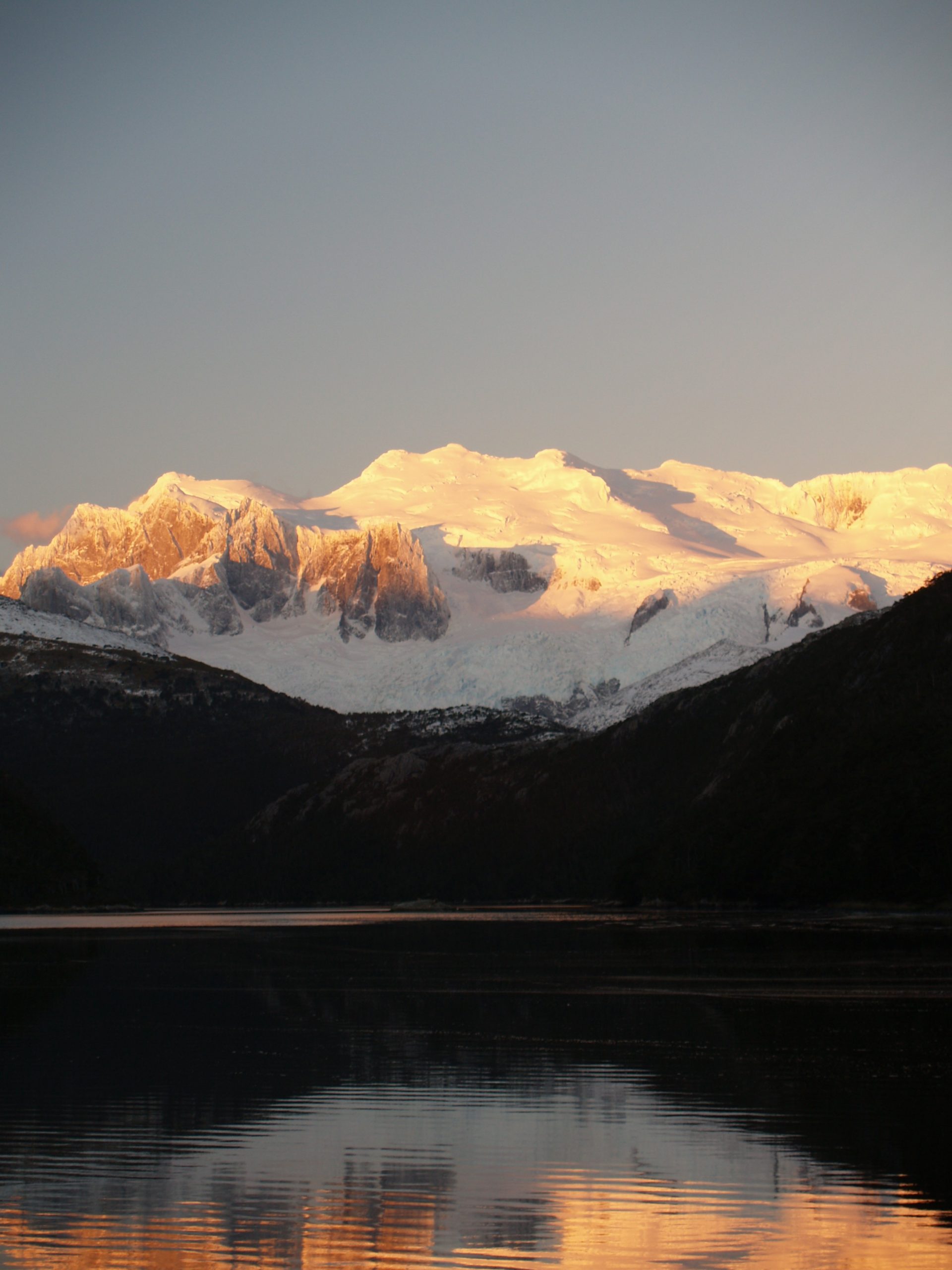 The central peaks of Cordillera Darwin, southern Chile, at sunset, viewed from Bahia Pia.  Photo credit: Brenda Hall.
