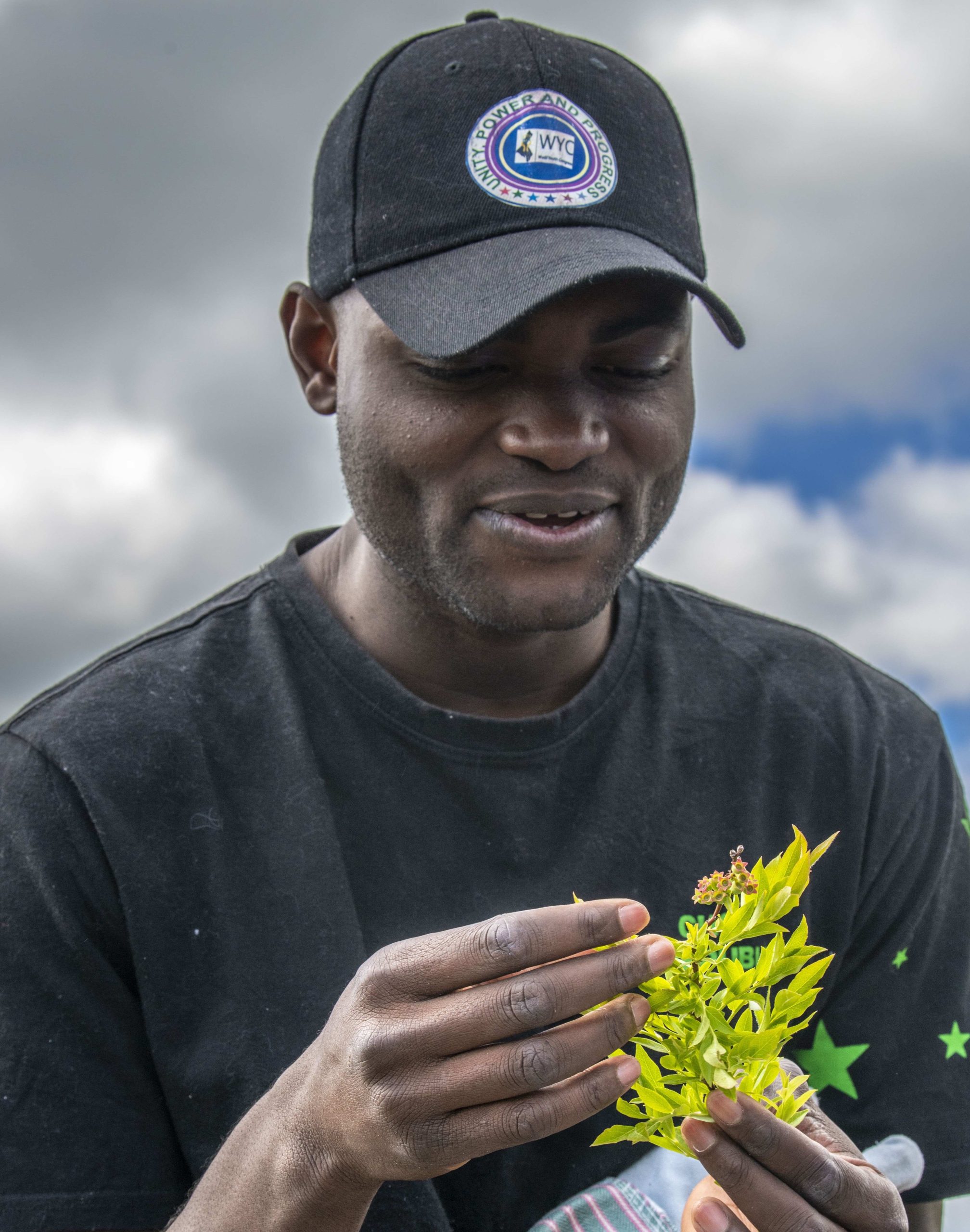 Ali Bello holding a plant