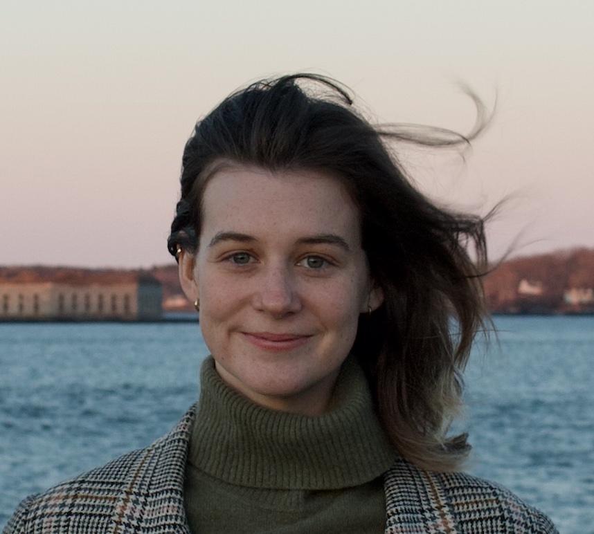 Ella McDonald posing in front of the water