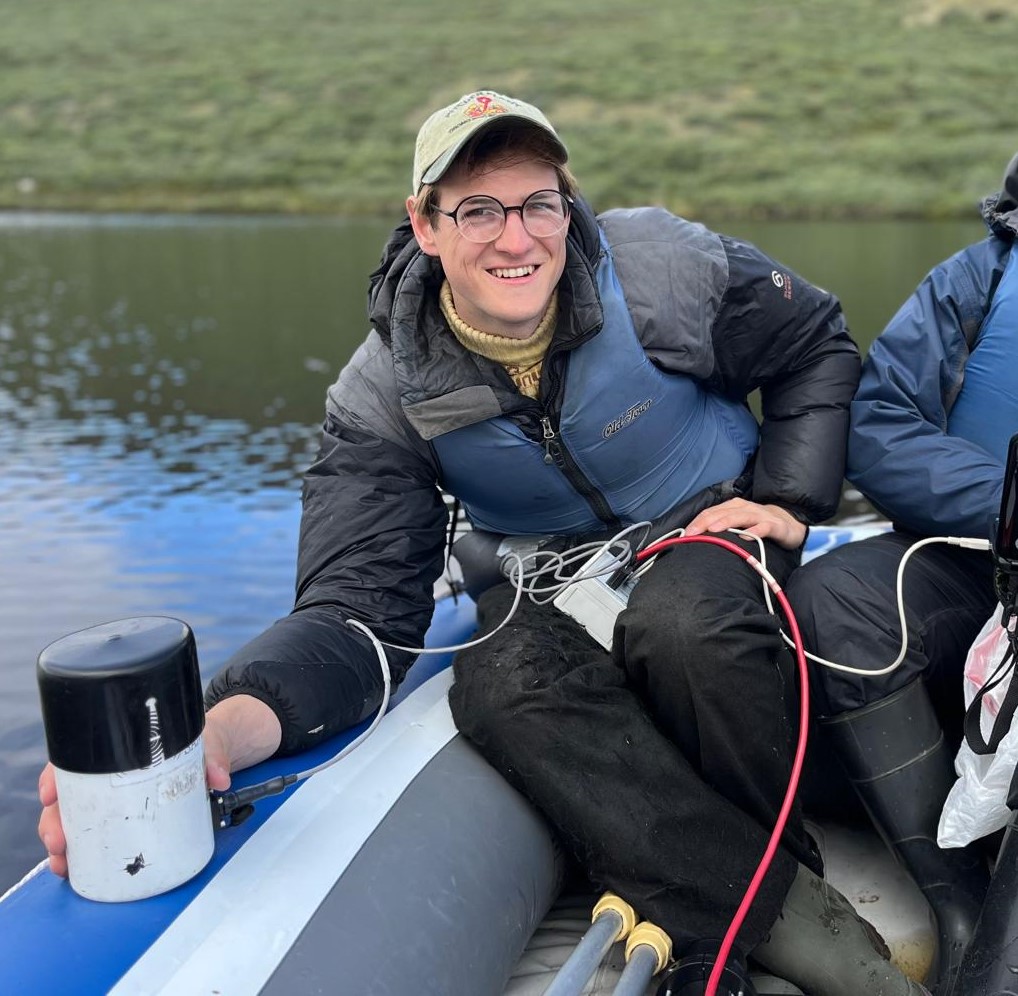Thomas Grindle posing in a boat on the water
