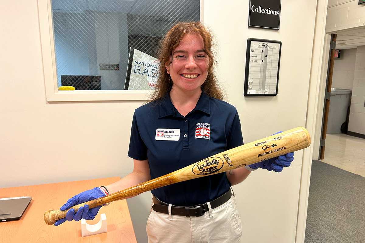 Delaney Colson holding a wooden baseball bat, photo.
