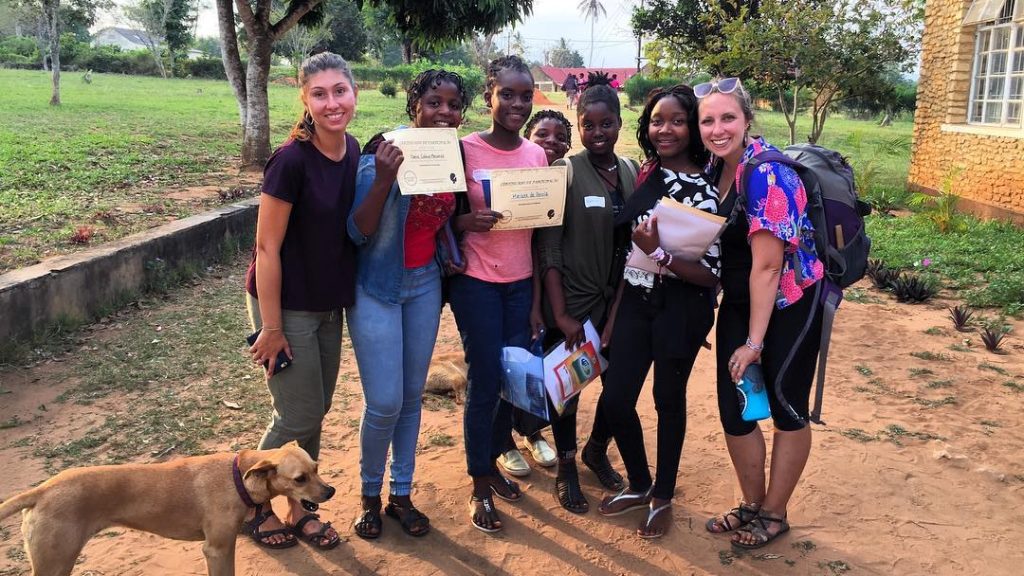 A photo of Katy Blackmer with a group at the Girls Empowerment Camp in 2018.