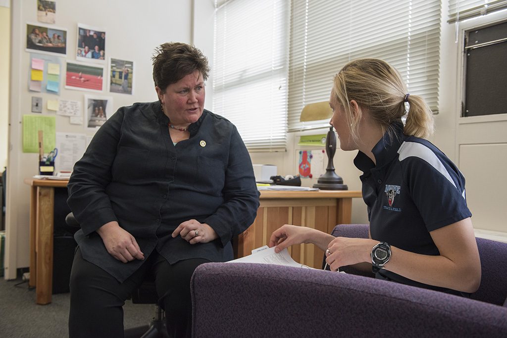 A photo of a student in conversation with a faculty member in an office