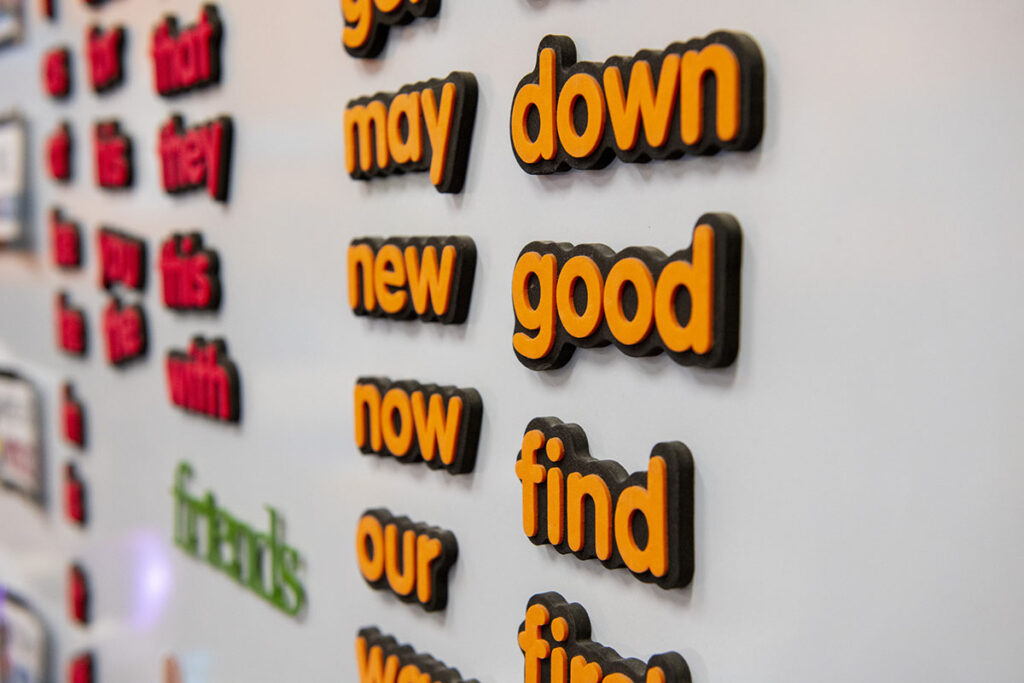 A picture of magnetic letters on a white board.