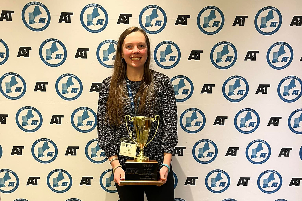 Emily Davison poses with her awards from the 2023 Eastern Athletic Trainers' Association convention.