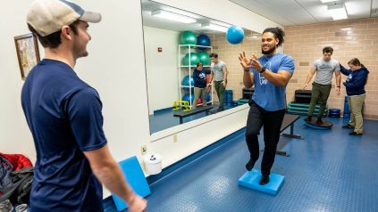 A photo of University of Maine athletic training students working on skills in the Wes Jordan Athletic Training Education Center..