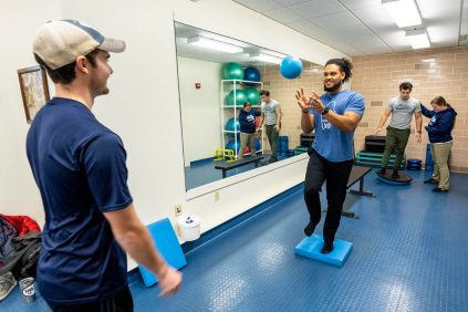 A photo of University of Maine athletic training students working on skills in the Wes Jordan Athletic Training Education Center..