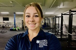 Julianna Cleaves poses for a photo in the Lengyel Hall weight room.