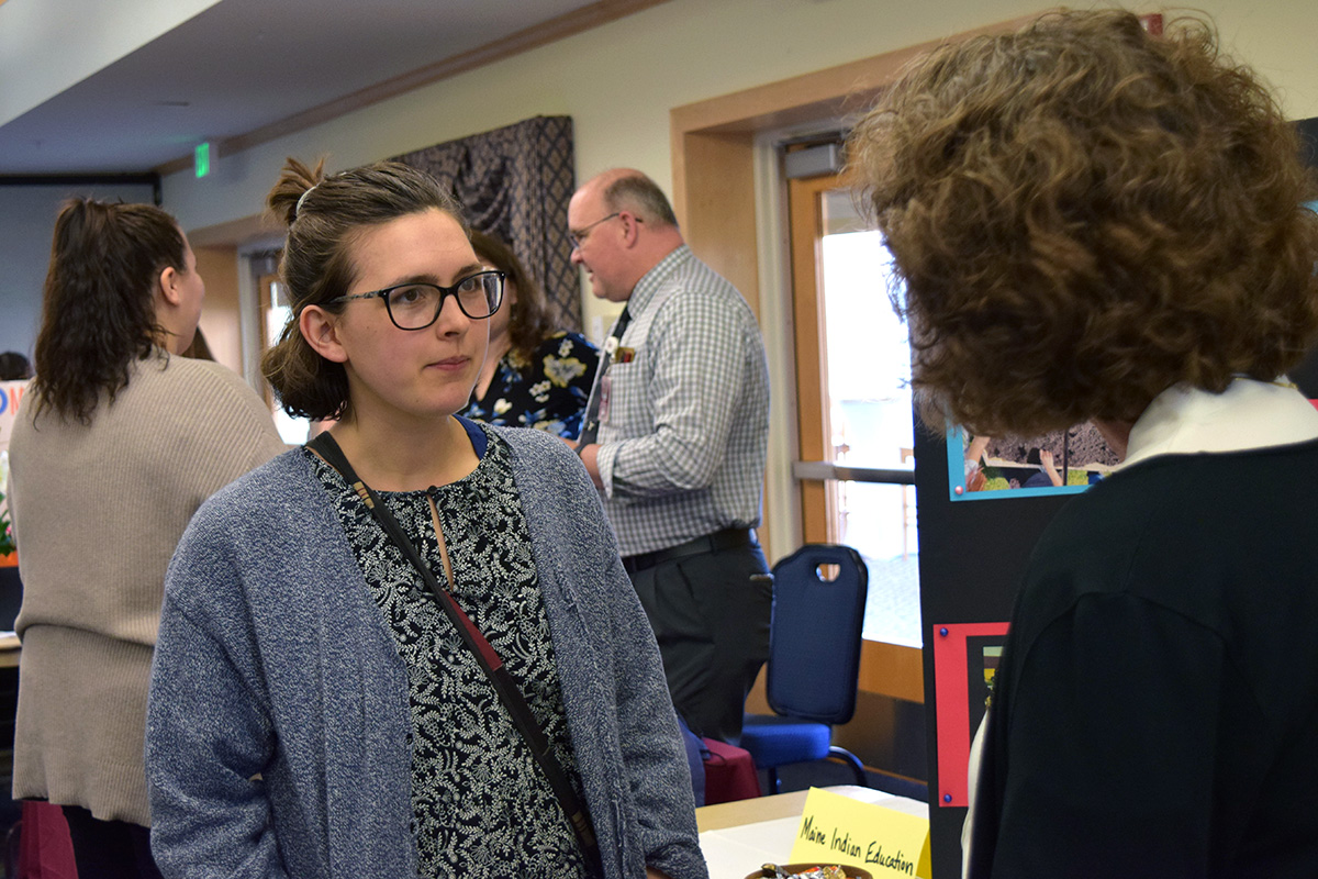 Natalie McCarthy, the 2023 outstanding graduating student in elementary education from the University of Maine College of Education and Human Development, talks to an employer at the college's 2023 education career fair.