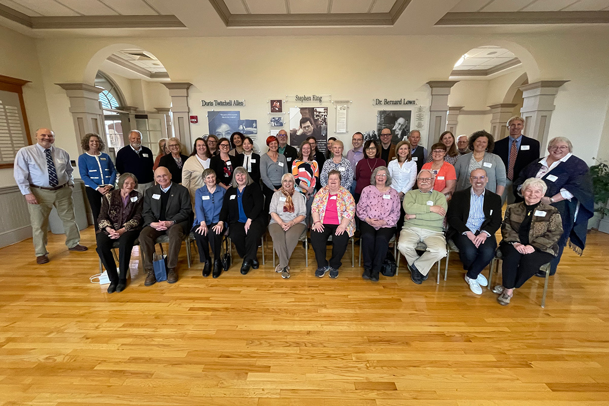 Current and former faculty and staff members from the University of Maine College of Education and Human Development pose for a photo at Buchanan Alumni House during the college's 2024 Legacy Tea event.