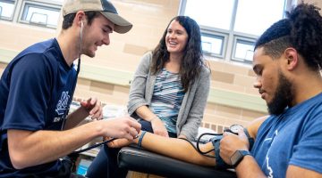 Assistant Professor of Athletic Training Alicia Lacy (middle) works with students at the Wes Jordan Athletic Training Education Complex on the University of Maine campus.