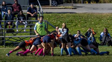 A picture of a rugby scrum during a women's club match at the University of Maine.