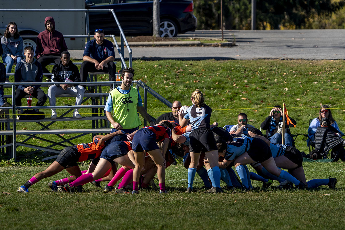 A picture of a rugby scrum during a women's club match at the University of Maine.