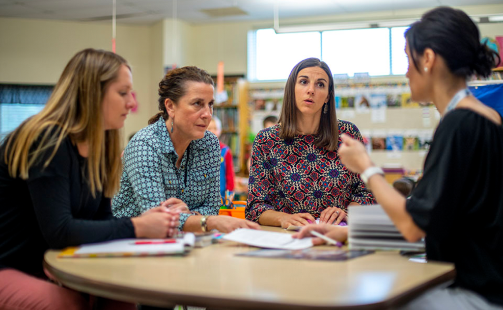 A photo of women around a table