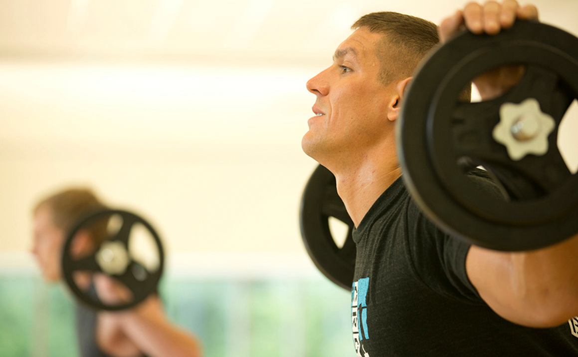 A photo of a man lifting weights
