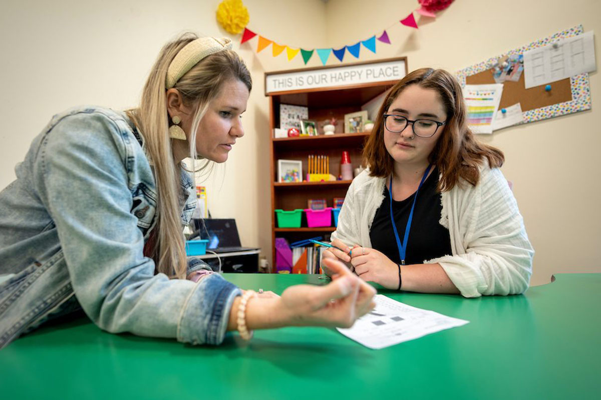 Patricia A. Duran teacher Julie Zucchi and College of Education and Human Development student Avery Morrell work together in Zucchi's classroom.