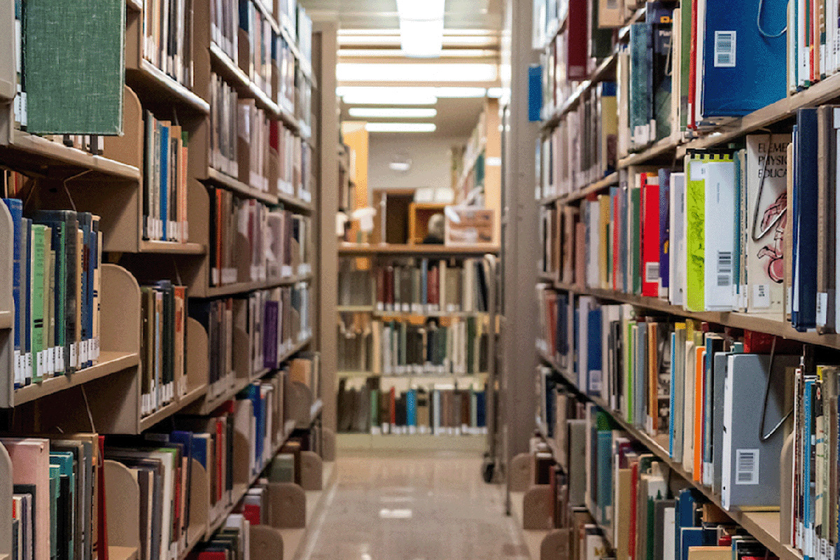 A photo of books on shelves in a library.
