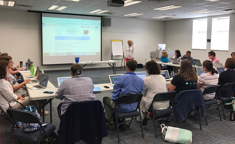 A photo of people in a conference room