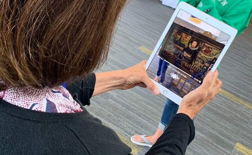 A photo of a person looking at a tablet