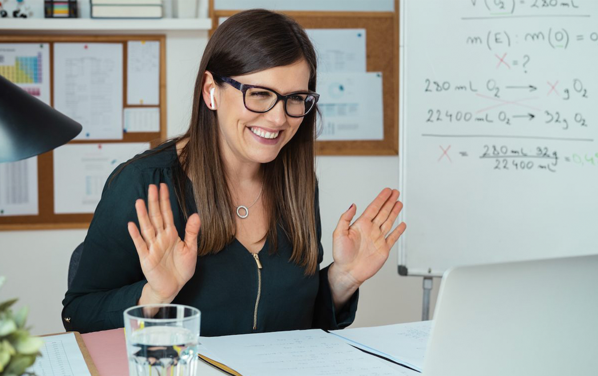 Smiling online teacher say hello to classroom in video conference meeting