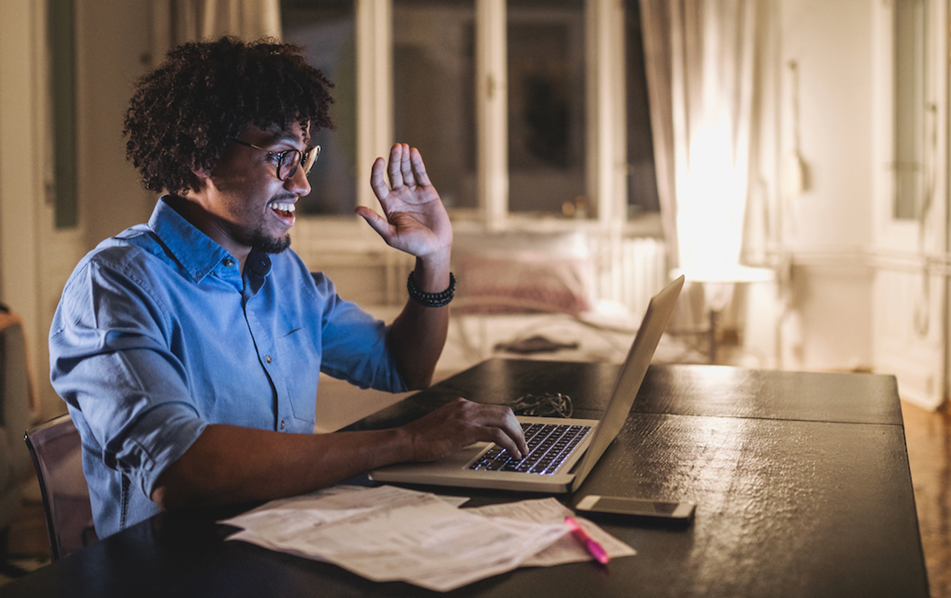 A photo of a man at a laptop