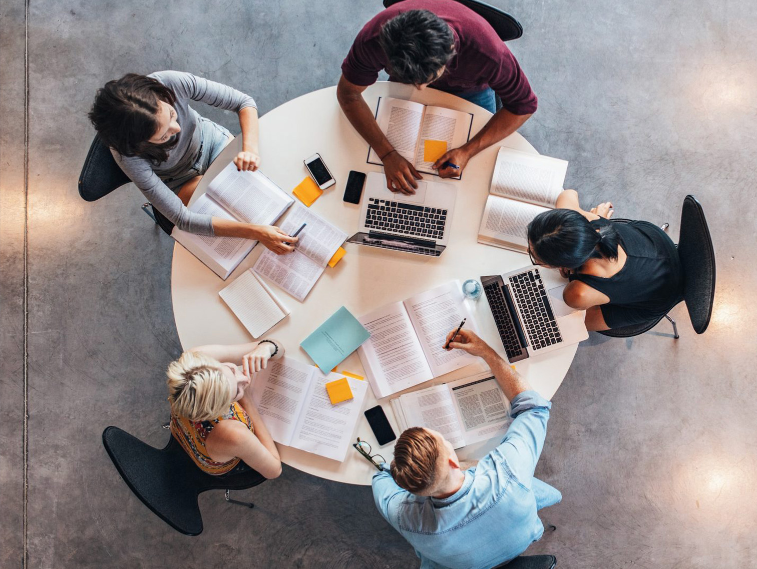 Top view of group of students sitting together at table.
