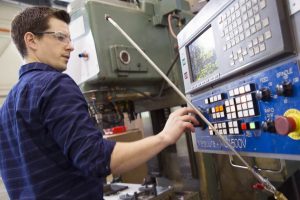 student programming a machine