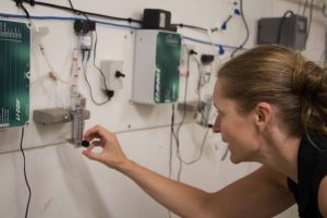 Female faculty member working on equipment in the new SEANET OA Lab