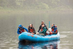 Group of five male researchers rafting on the Penobscot River 