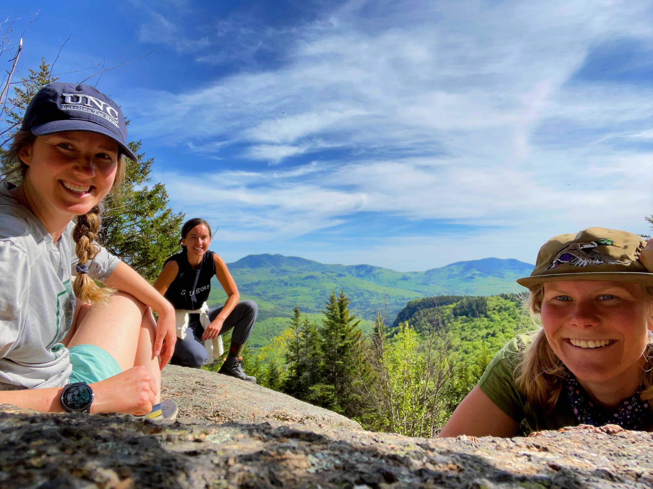 Three individuals pose at the top of an elevation.