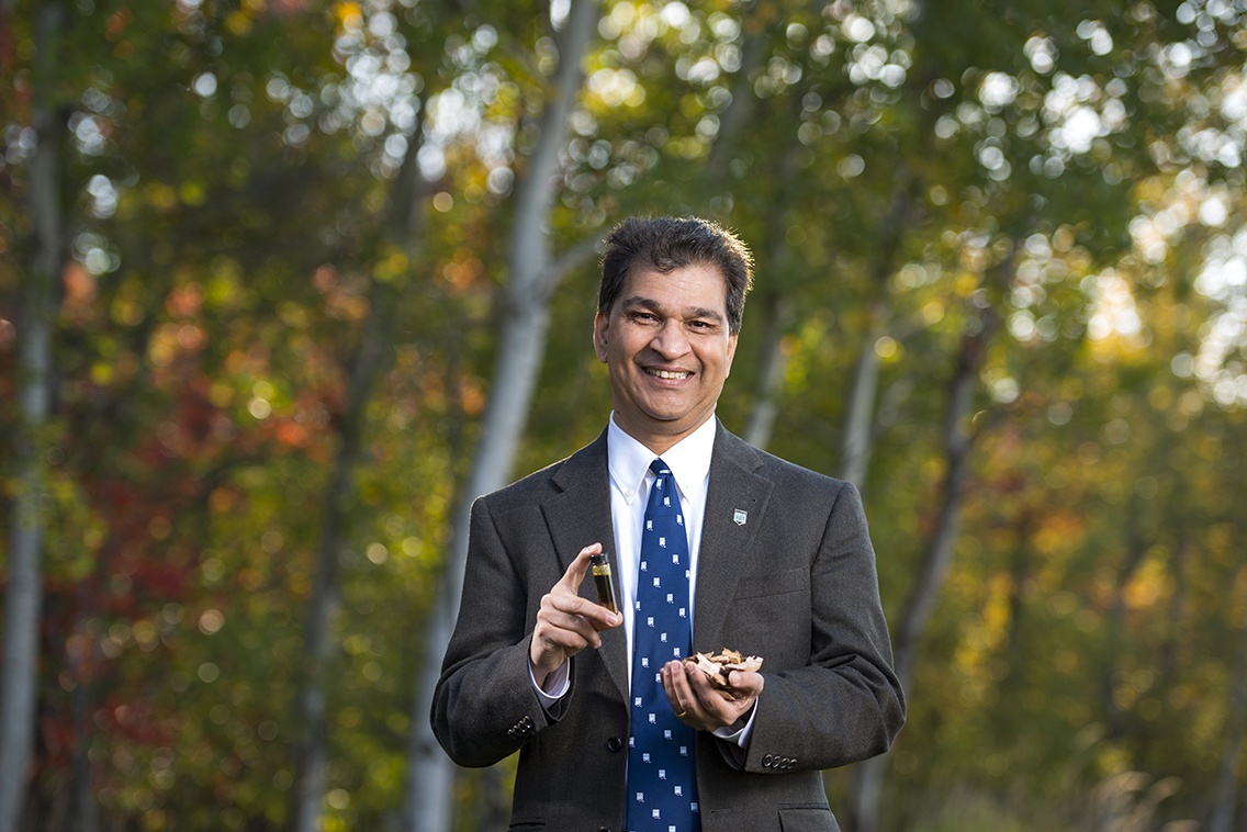 Hemant Pendse stands in front of trees