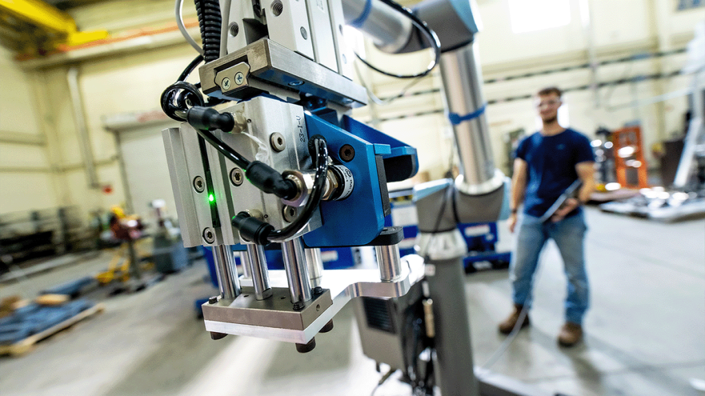 researchers stand around industrial equipment