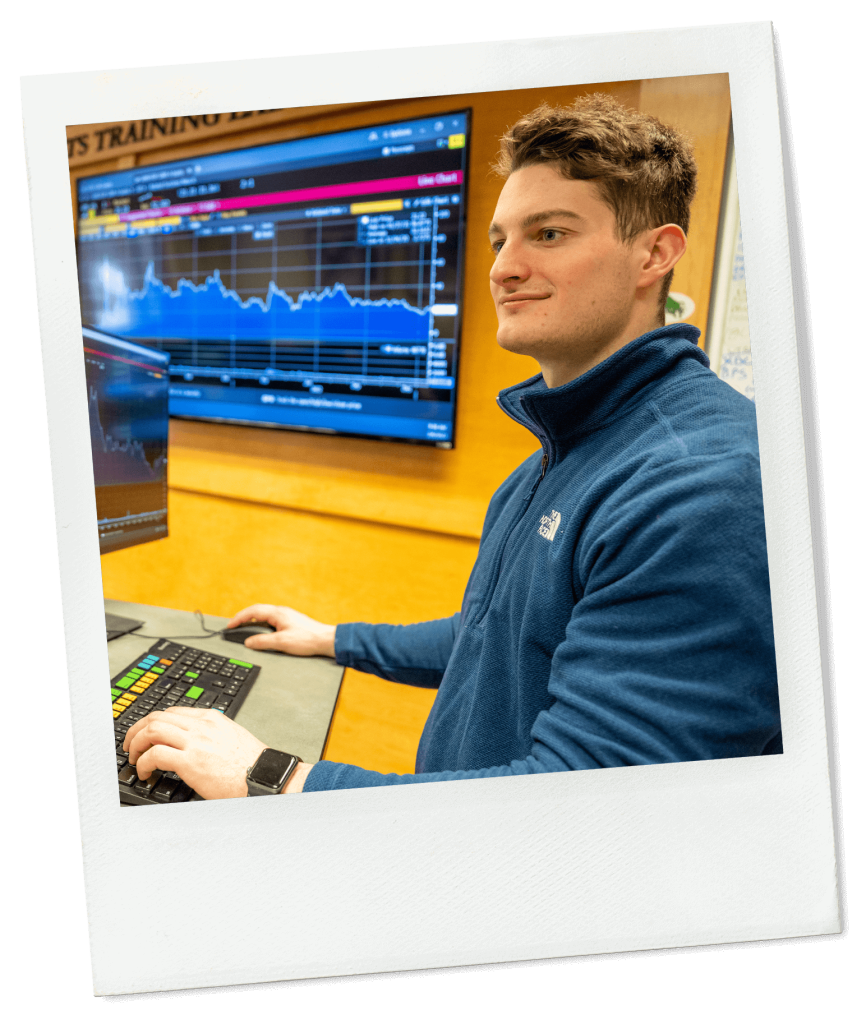 A photo of a business student using a Bloomberg Terminal in a lab classroom