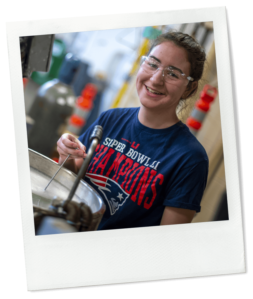 A photo of a chemistry student taking the temperature of a liquid