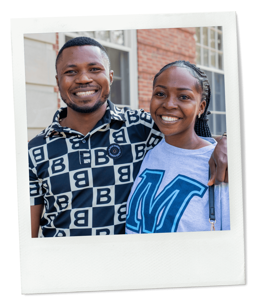 A photo of two students smiling at the camera