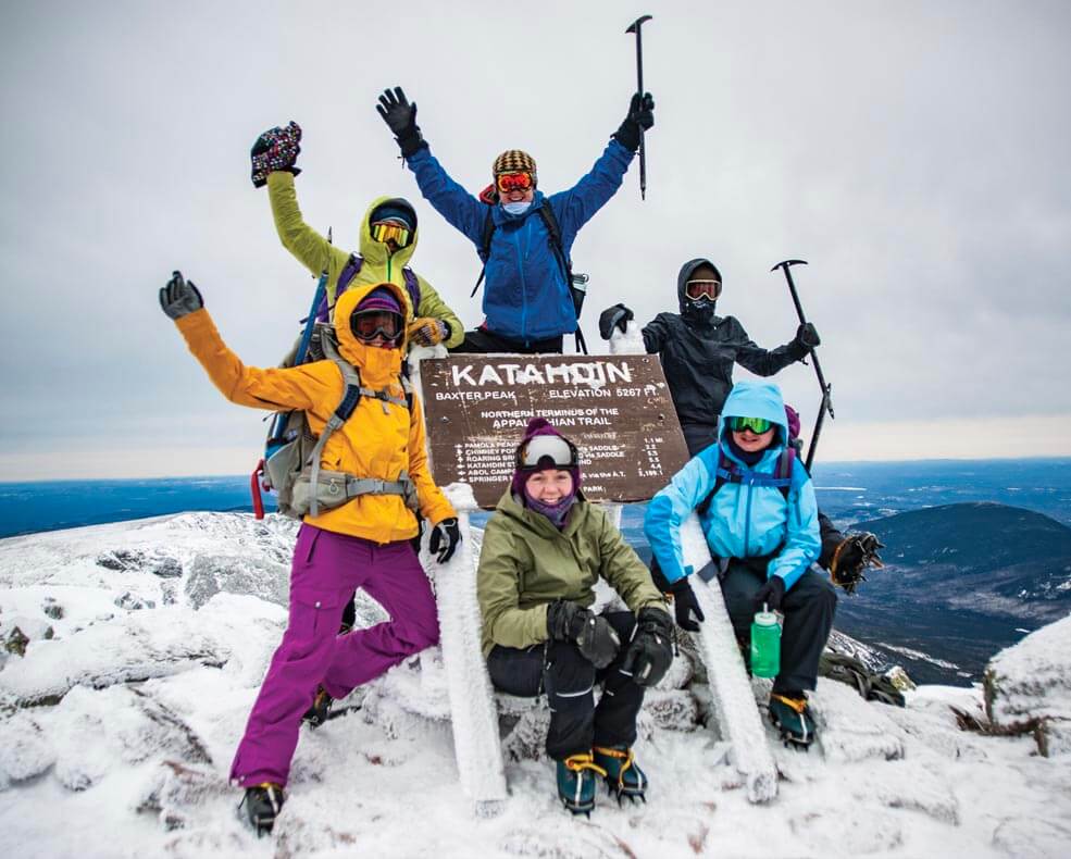 A photo of students on the top of snowy Mount Katahdin