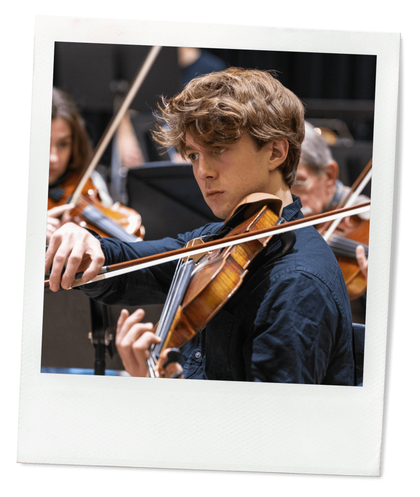 A photo of a student playing a violin