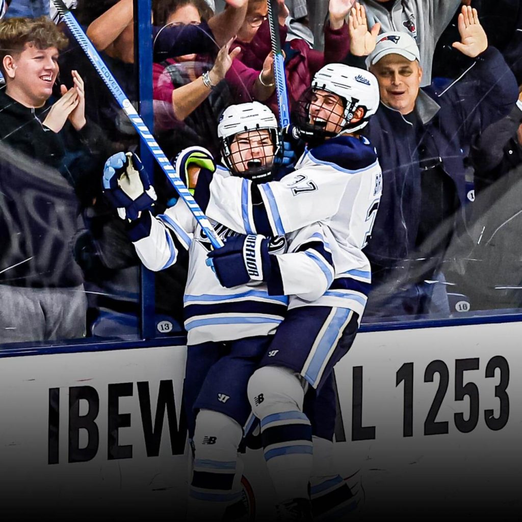 A photo of two hockey players celebrating after a goal