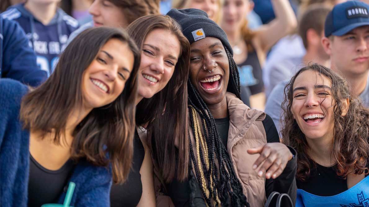 A photo of football fans laughing and smiling