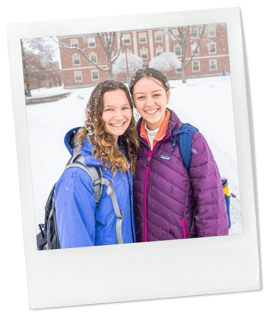 A photo of two people standing in the snow and smiling