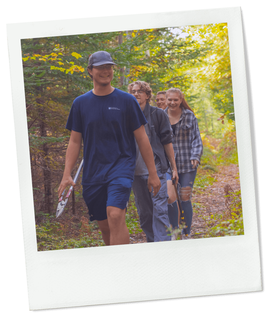 A photo of students walking in a forest